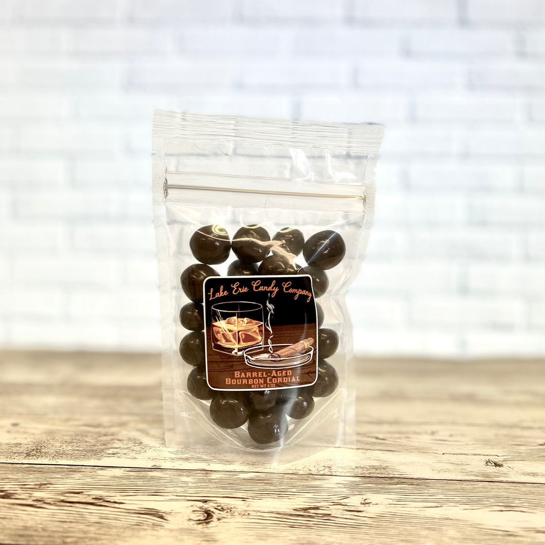 Clear bag of Lake Erie Candy Company barrel aged bourbon cordials with a wooden background