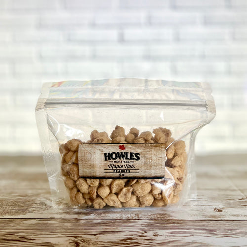 Clear bag of the Howle's maple peanuts on a wooden background