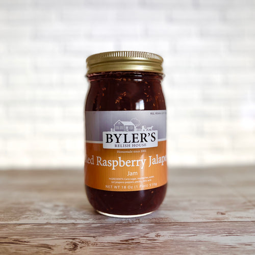 Can of Byler's red raspberry jalapeno jam on a wooden background