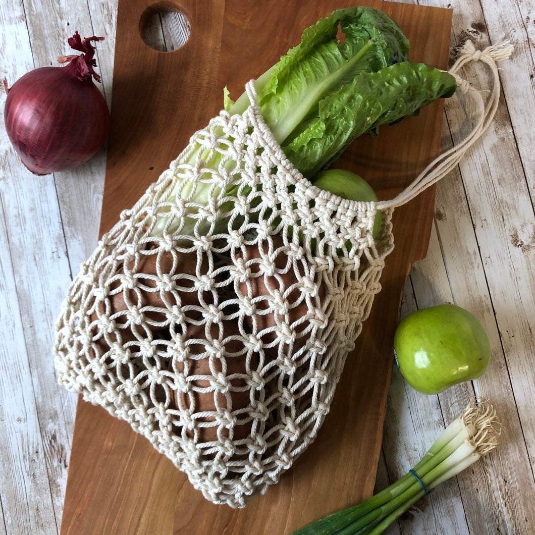 Macrame Market Bag filled with lettuce, potatoes and onions to show how bag works
