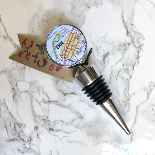 Agatha and Emily Erie map wine bottle stopper on a white marble background