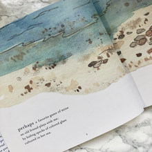 Load image into Gallery viewer, Page of the Mother Beach book on a white marble background
